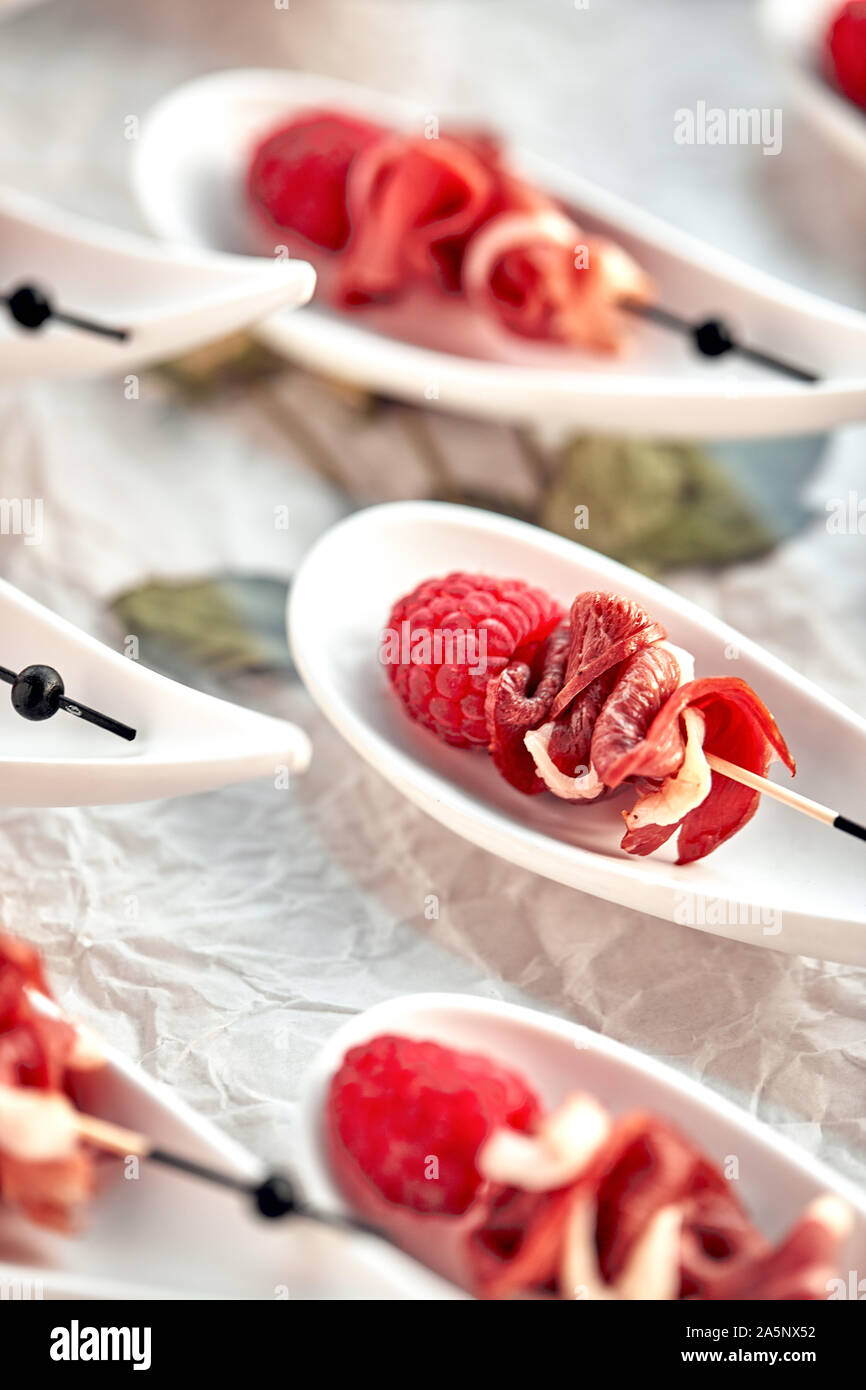 Delicious canapes hamon with raspberries. Concept of food, restaurant ...