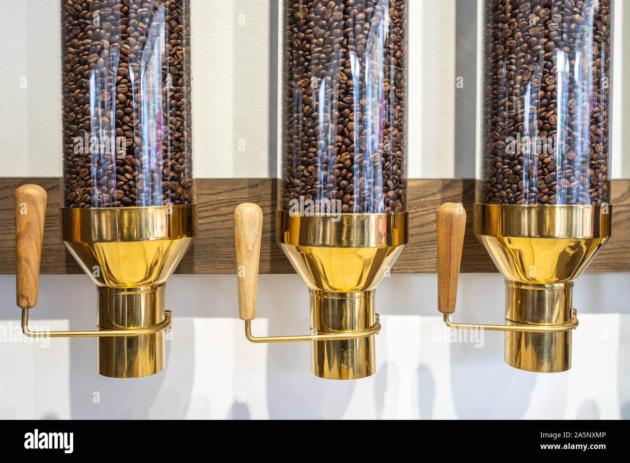 Coffee bean contained within three luxury transparent canisters Stock Photo