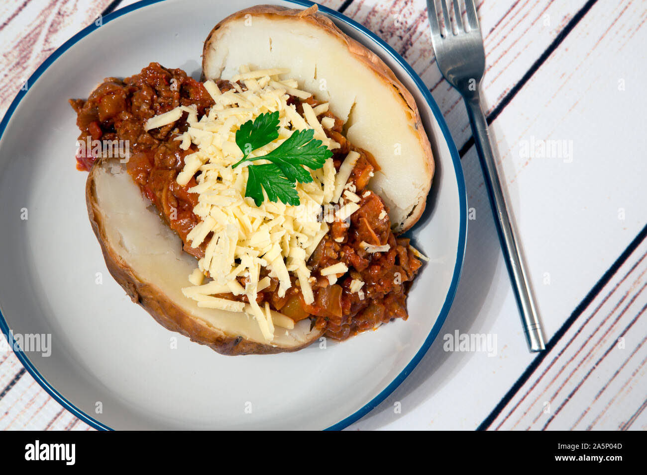 Baked Jacket potato with Quorn chili and vegan cheese topping Stock
