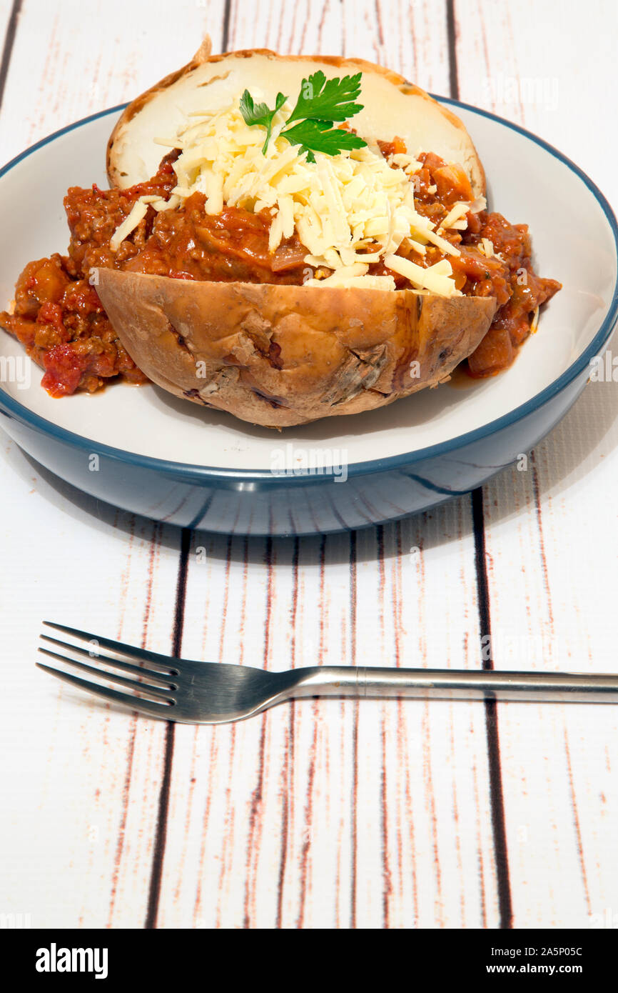 Baked Jacket potato with Quorn chili and vegan cheese topping Stock