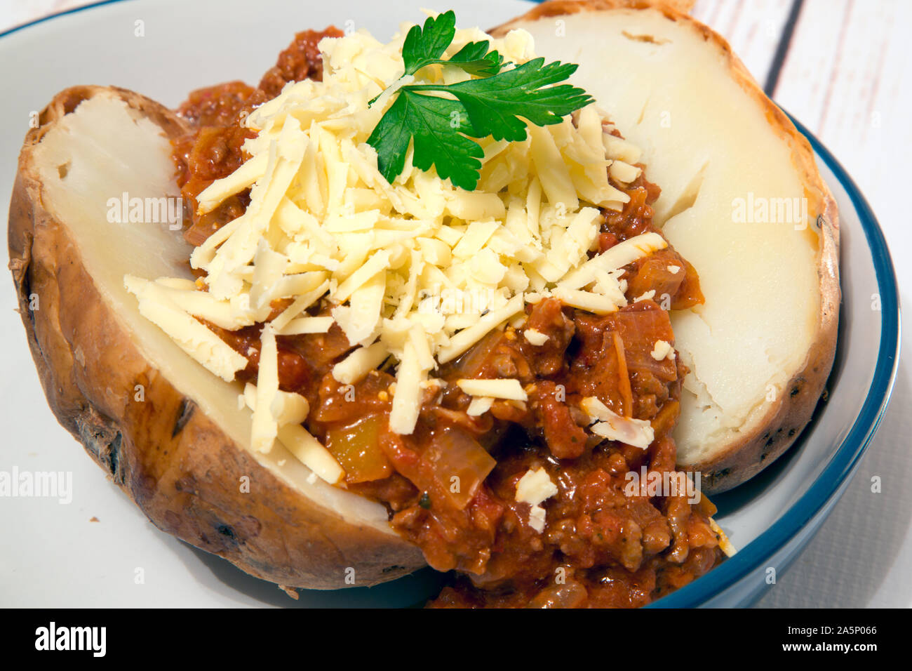 Baked Jacket potato with Quorn chili and vegan cheese topping Stock