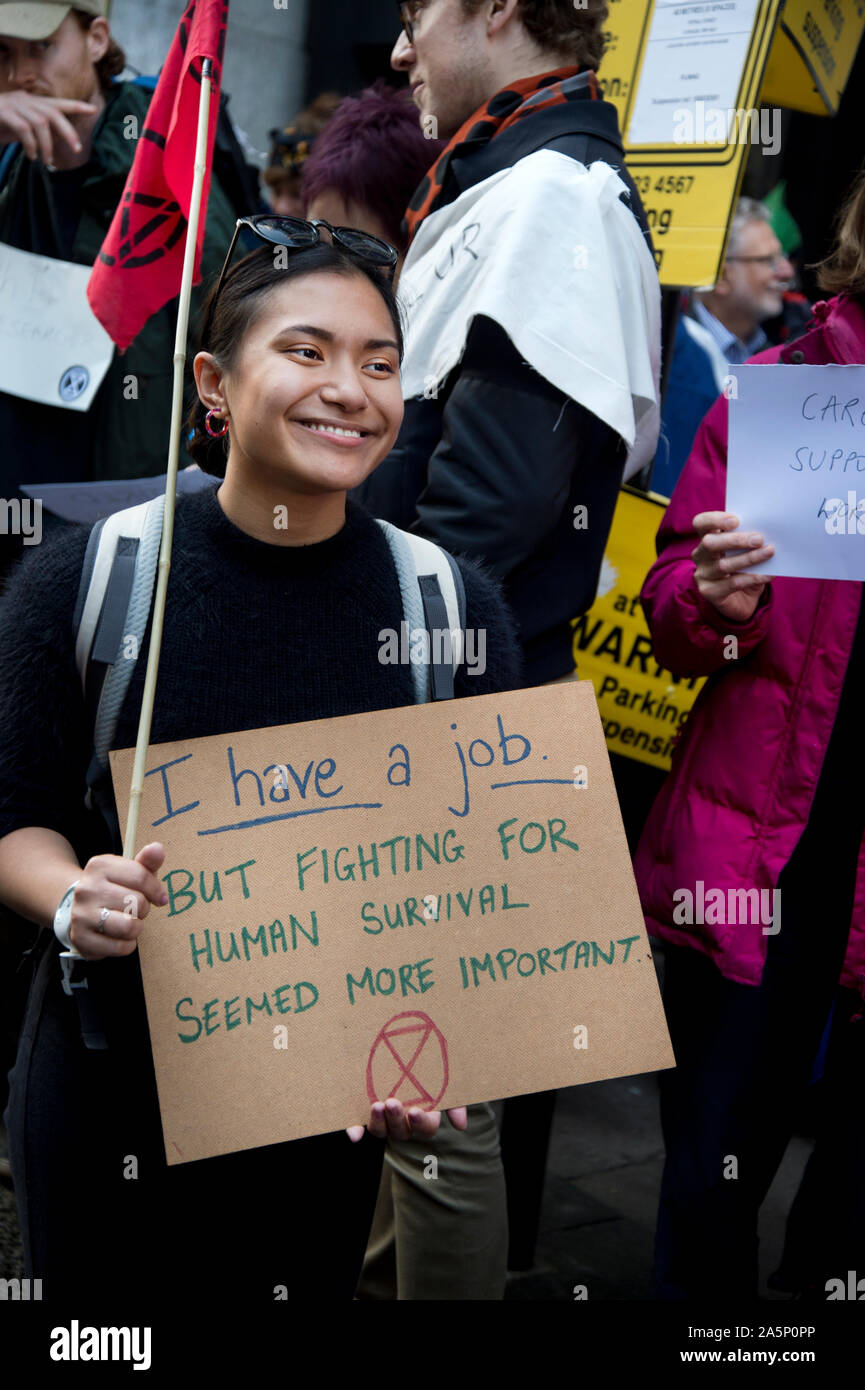 Extinction Rebellion,  London, October 17th 2019. Outside the Department of Work and Pensions. XR activists hold signs showing they have jobs. Stock Photo