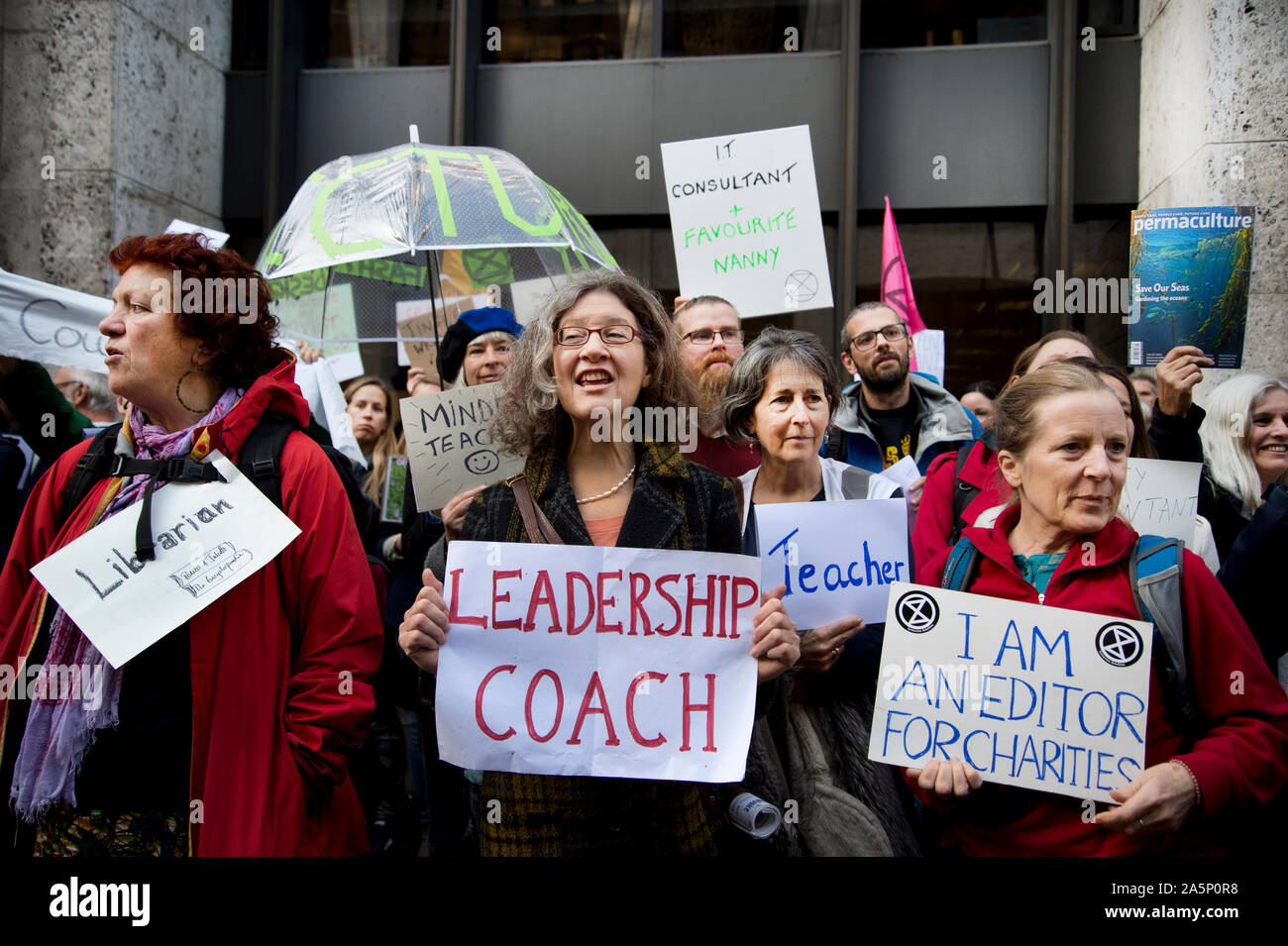Extinction Rebellion,  London, October 17th 2019. Outside the Department of Work and Pensions. XR activists hold signs showing they have jobs. Stock Photo