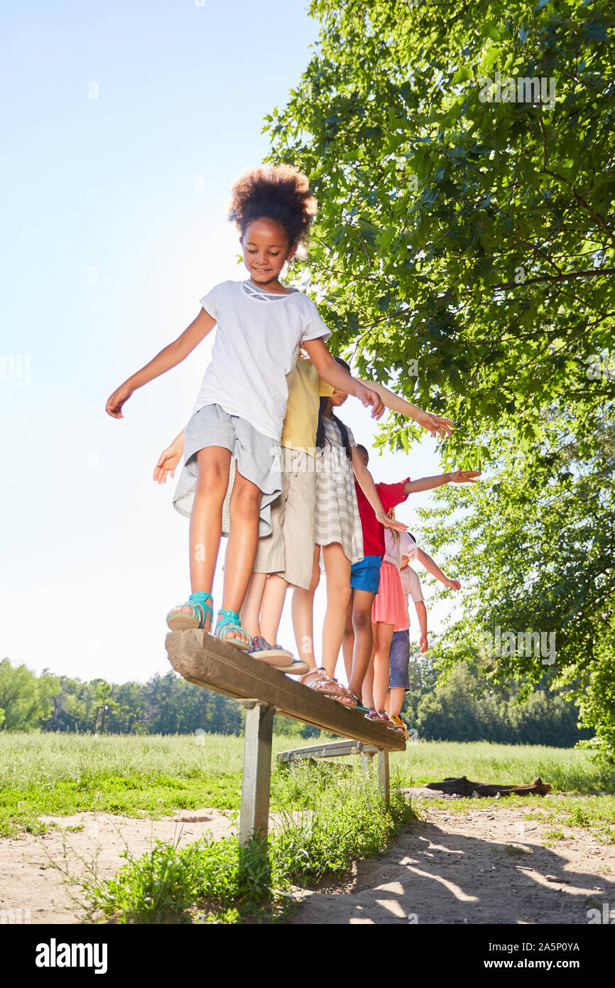 Group of kids balances on a beam for fitness and balance Stock Photo ...