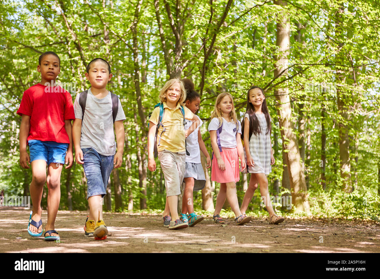 Group of multicultural kids is making outing or hiking day in nature Stock Photo