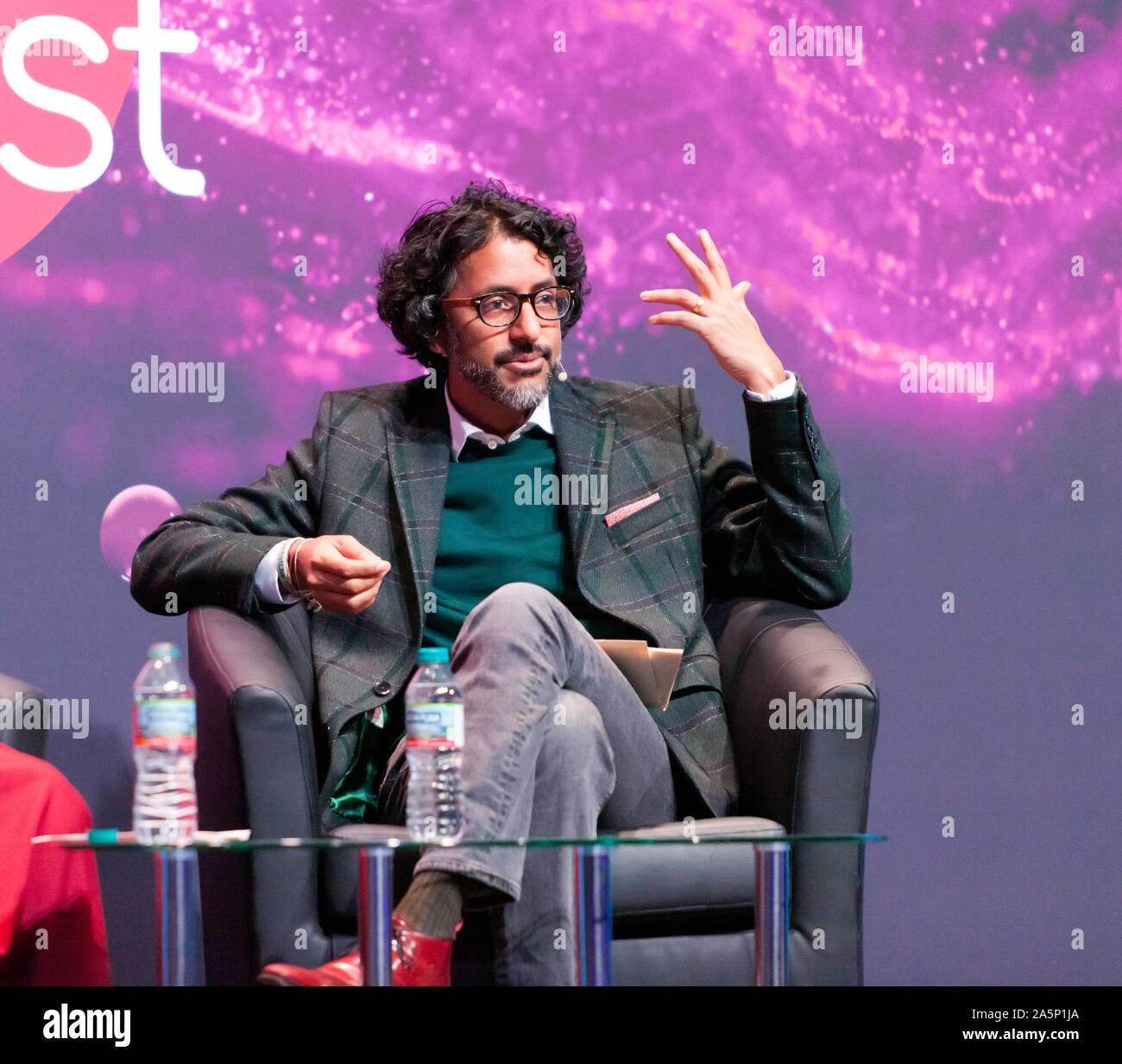 Ash Ranpura, Neuroscientist and clinical neurologist, discussing Who are we? A conversation between Buddhism and Neuroscience, on the Main Stage at New Scientist Live 2019 Stock Photo