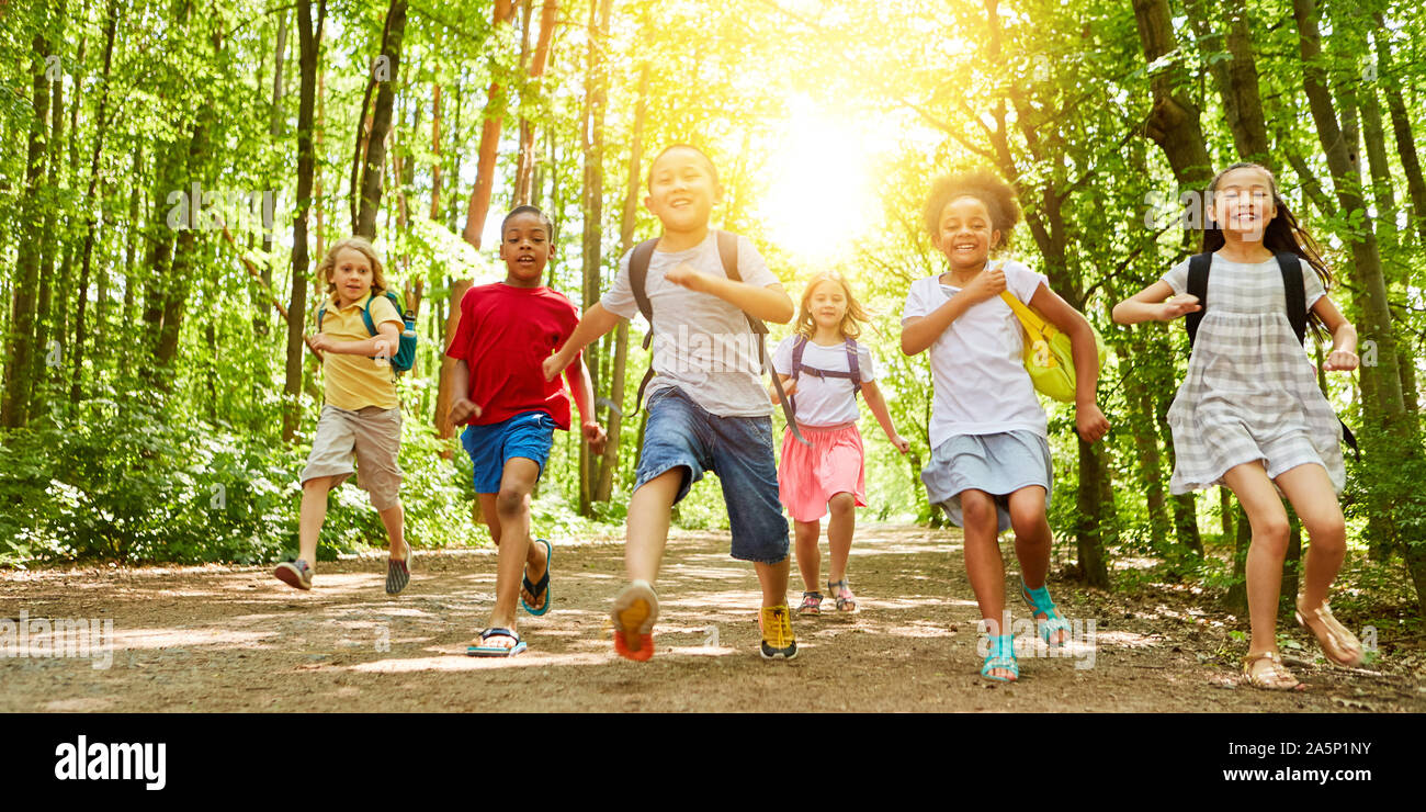 Happy kids run together to summer camp in nature Stock Photo - Alamy