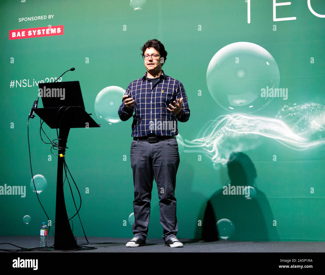 Christos Bergeles, Senior lecturer at  King's College London,  explaining how micro-robotics can be used to help cure blindness, On the Technology Stage at New Scientist Live 2019 Stock Photo