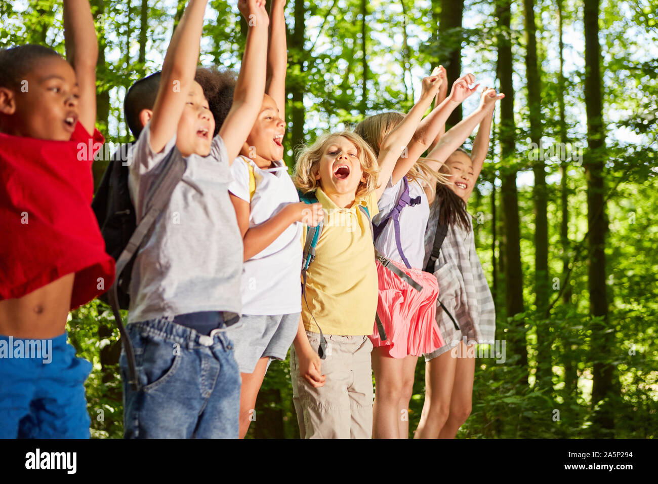 Group of kids cheer on the tour or hiking day in nature Stock Photo