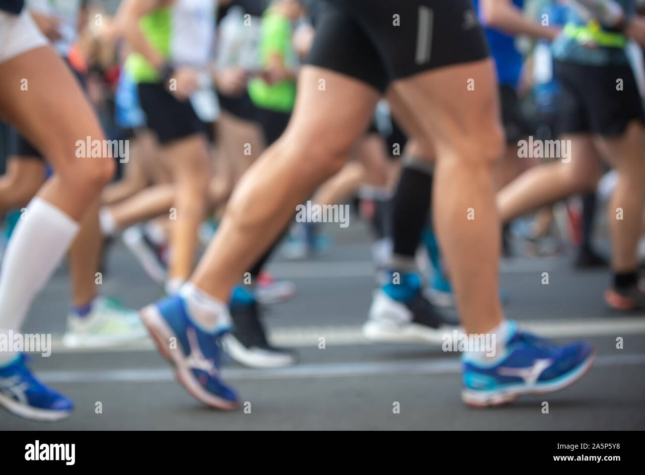 Marathon runners, running on the city road. Stock Photo