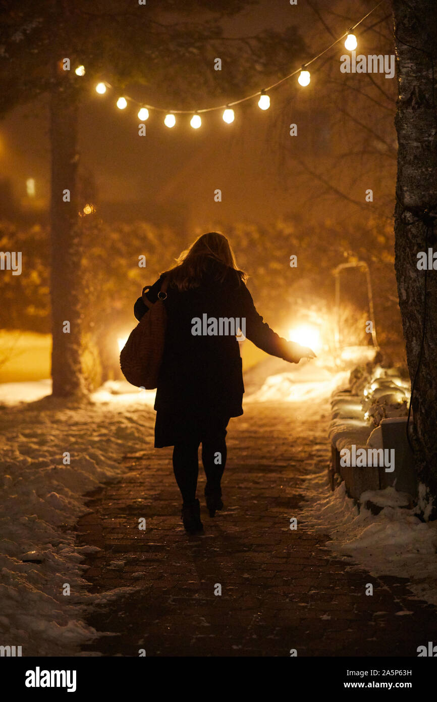 Woman walking rear view night hi-res stock photography and images - Alamy