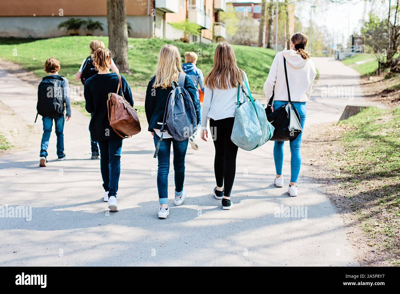 Rear view girls friends walking hi-res stock photography and images - Alamy