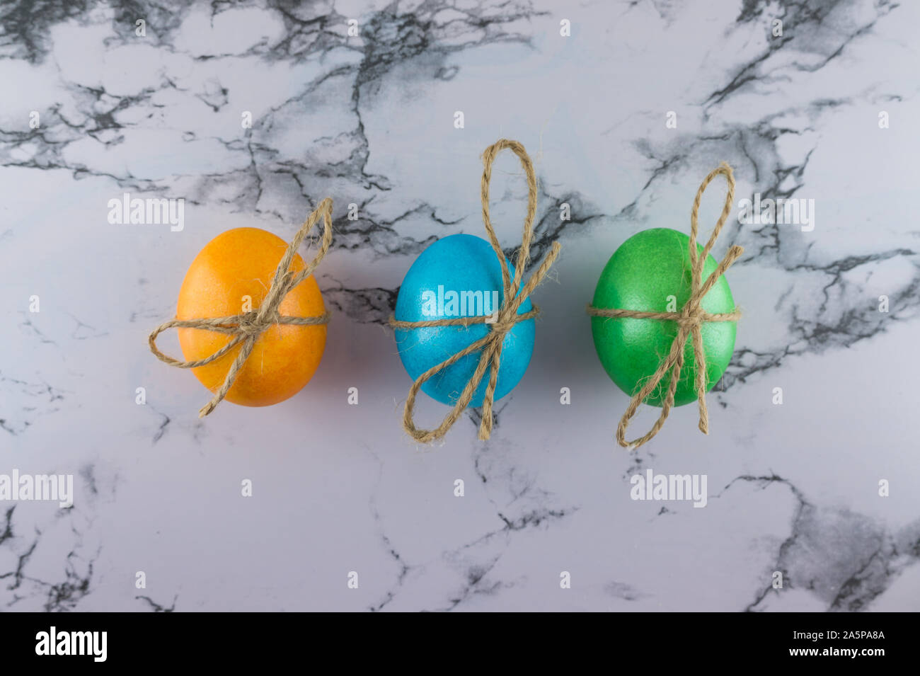 Marble Easter flat lay background with painted Easter eggs. Place for text. Stock Photo