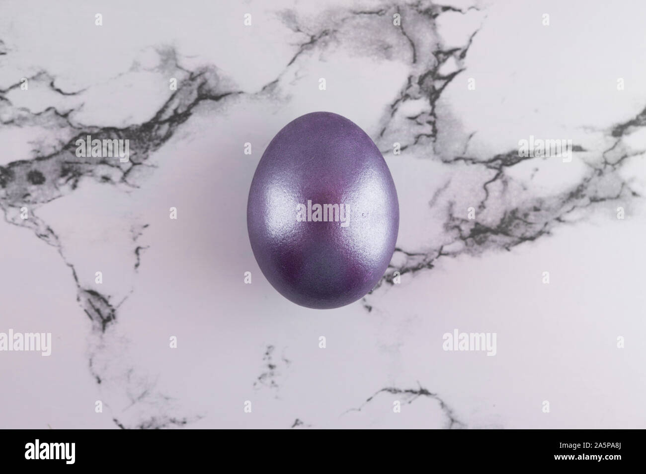 Marble Easter flat lay background with painted Easter egg. Stock Photo