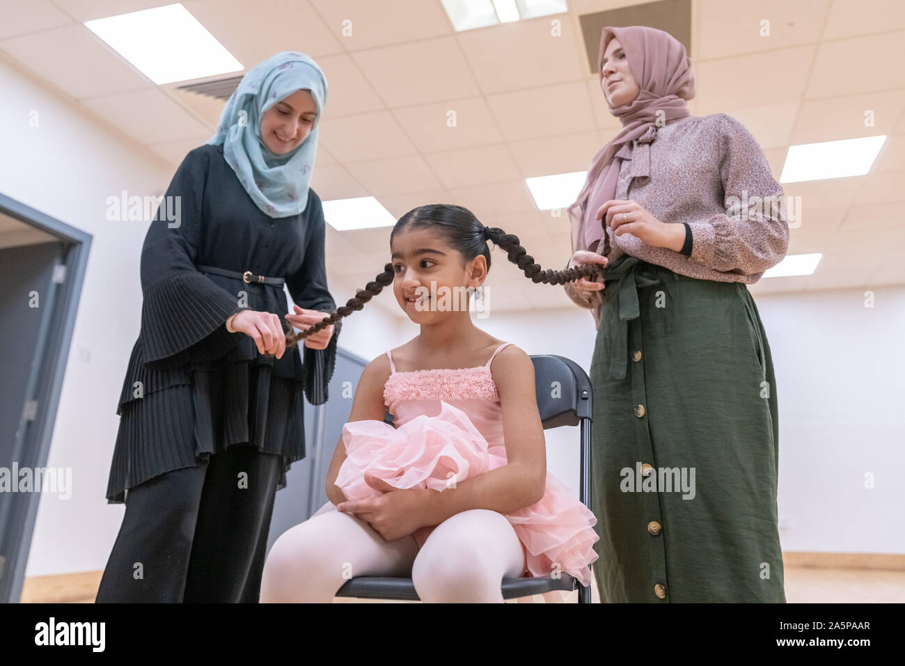 London, UK. 22nd Oct, 2019. World Ballet Day: Muslim Ballet School. Grace & Poise Academy. Founded in Jan 2019 by Maisie Alexandra Byers(pictured right), a graduate of the Royal Academy of Dance and Dr Sajedah Shabib(pictured left), business director, Grace & Poise Academy is the world’s first ballet school bringing ballet to the Muslim community.  Young dancer pictured: Halimah 4 yrs in chair. Credit: Guy Corbishley/Alamy Live News Stock Photo