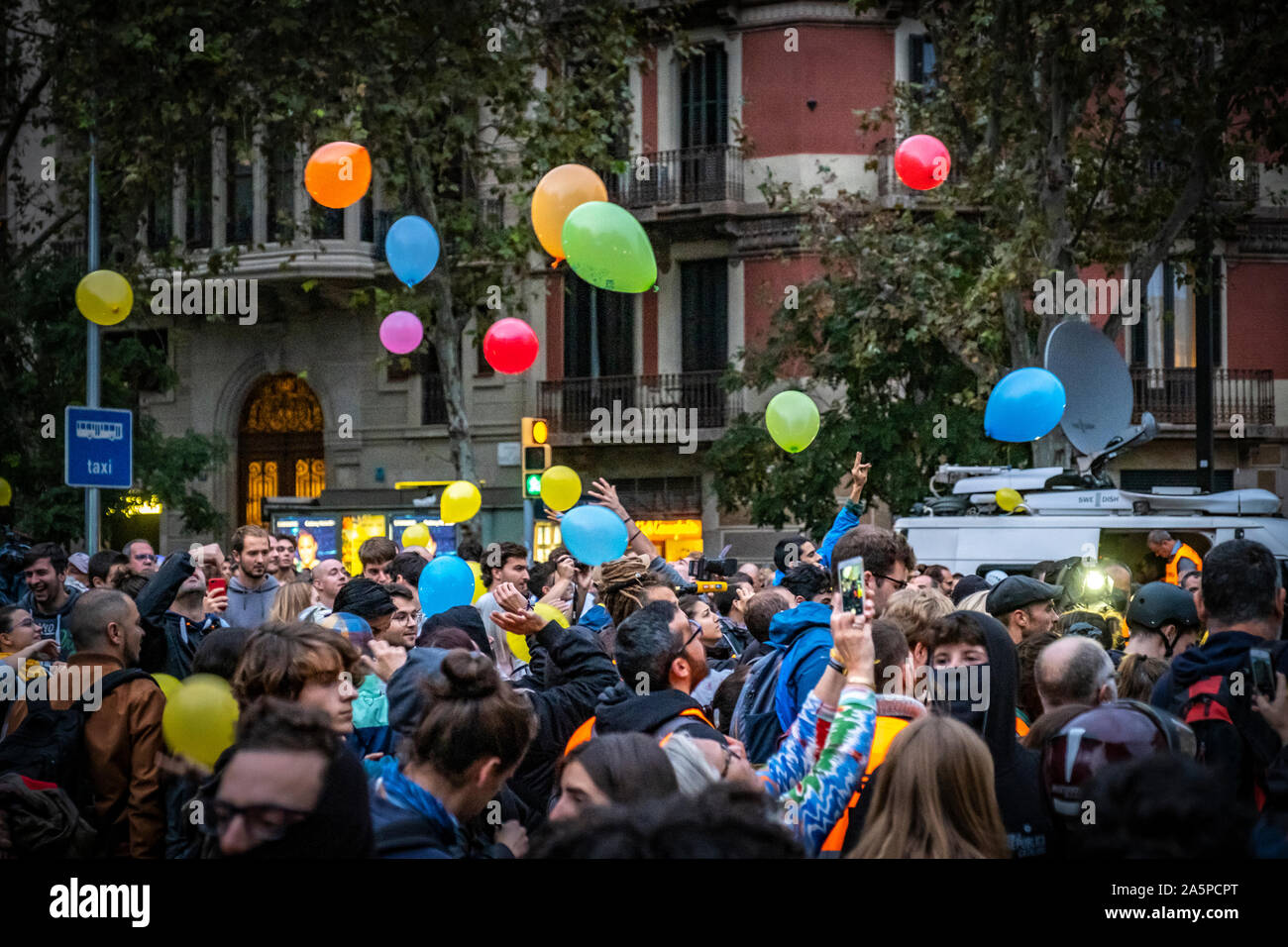 Protesters release colourful balloons in front of the Delegation of Interior.Hundreds of people gathered in front of the Department of Interior of the Generalitat de Catalunya to protest the Supreme Court sentences. The protest action consisted in the launch of paint balloons on the headquarters of the Interior. Stock Photo