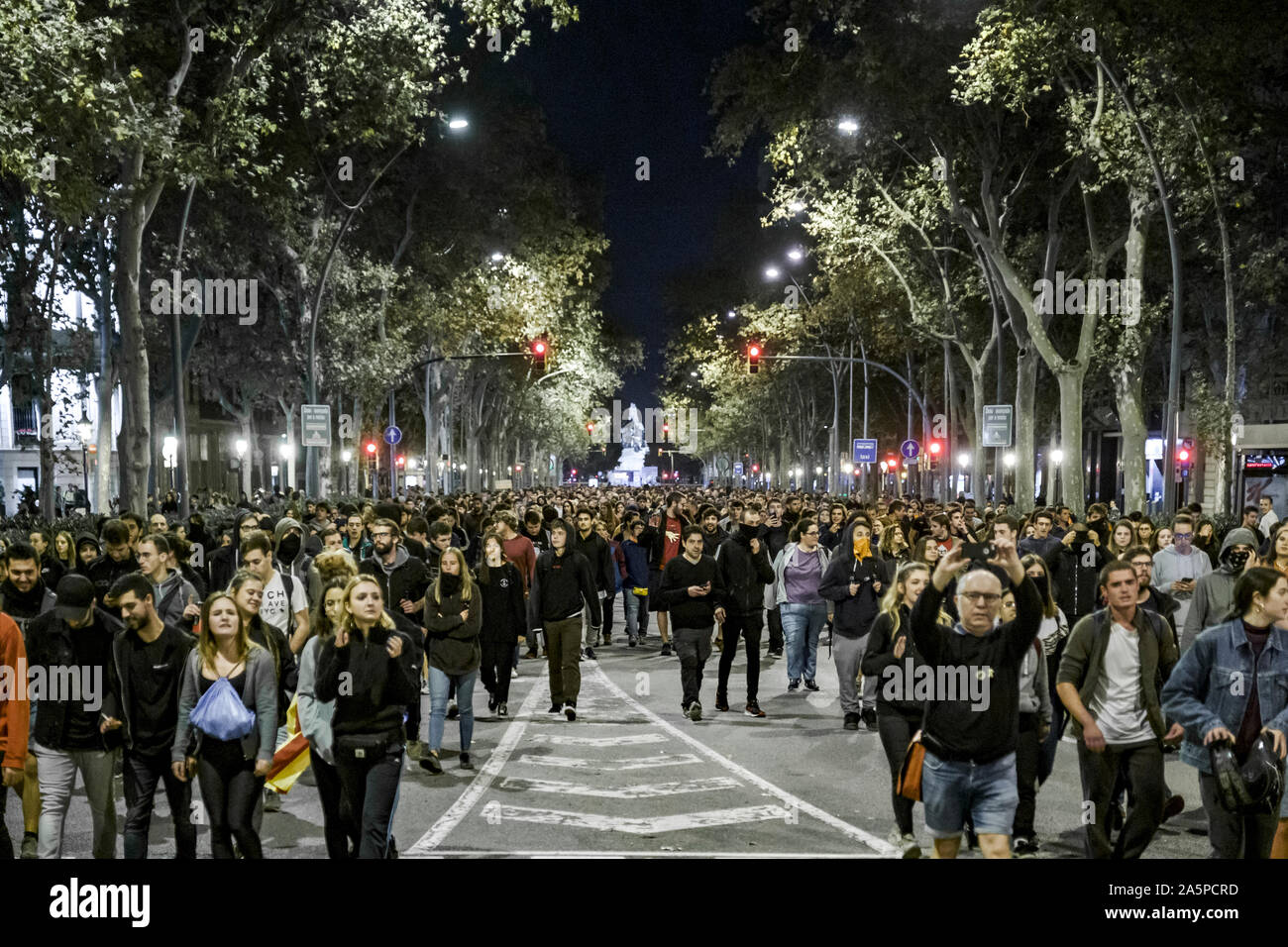 Crowds of protesters march along the Gran Vía after the launch of paint balloons in Passeig de Sant Joan.Hundreds of people gathered in front of the Department of Interior of the Generalitat de Catalunya to protest the Supreme Court sentences. The protest action consisted in the launch of paint balloons on the headquarters of the Interior. Stock Photo