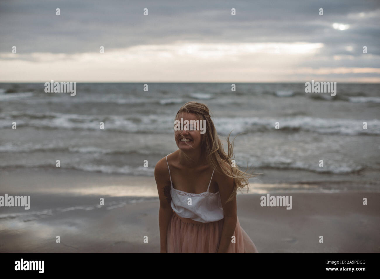 Happy woman on beach Stock Photo - Alamy