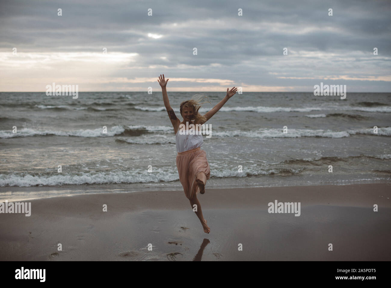 Happy woman on beach Stock Photo - Alamy