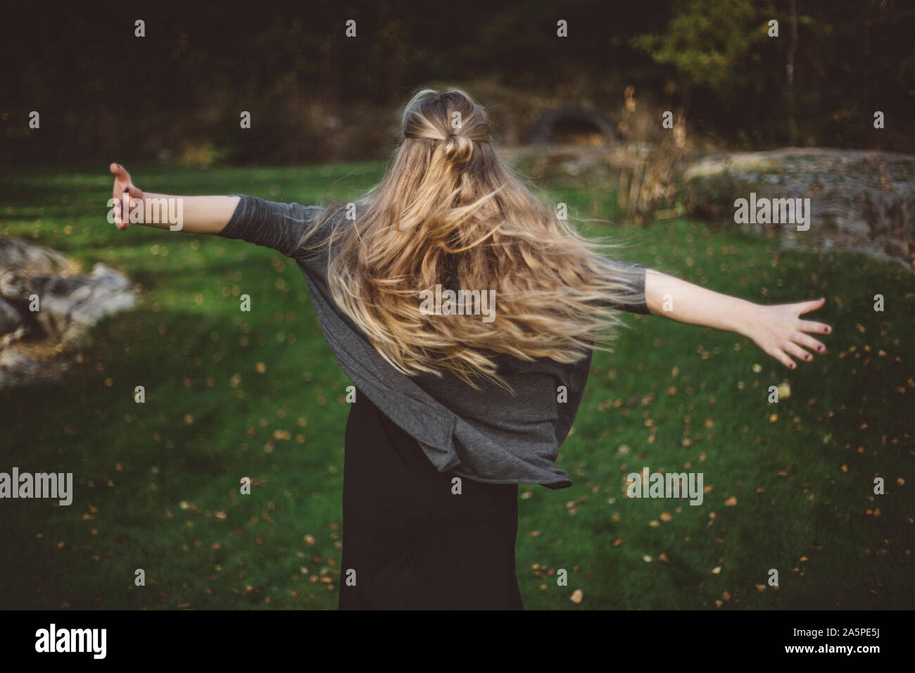 Blonde woman dancing rear view hi-res stock photography and images - Alamy