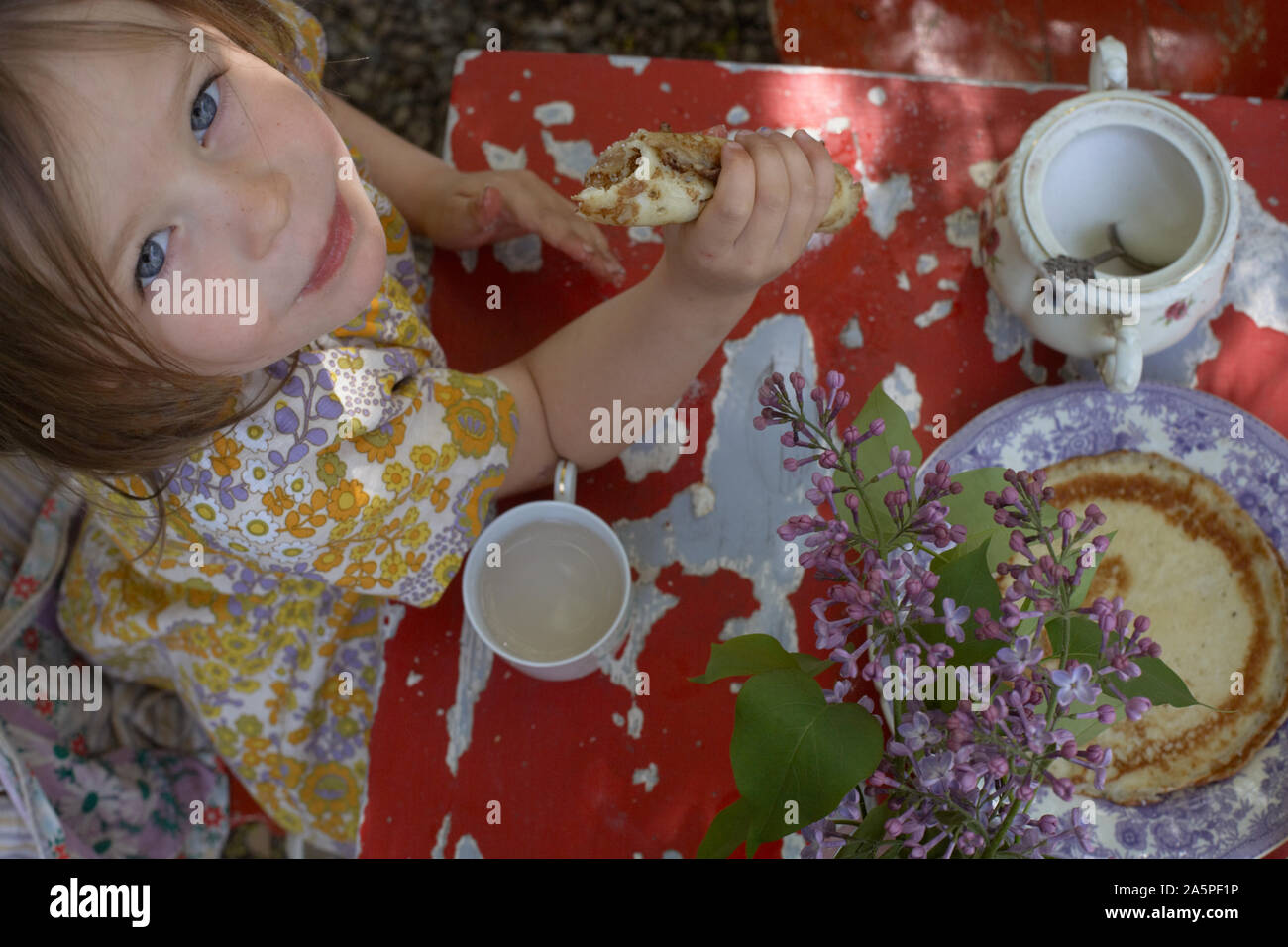 Girl having tea party in garden Stock Photo - Alamy