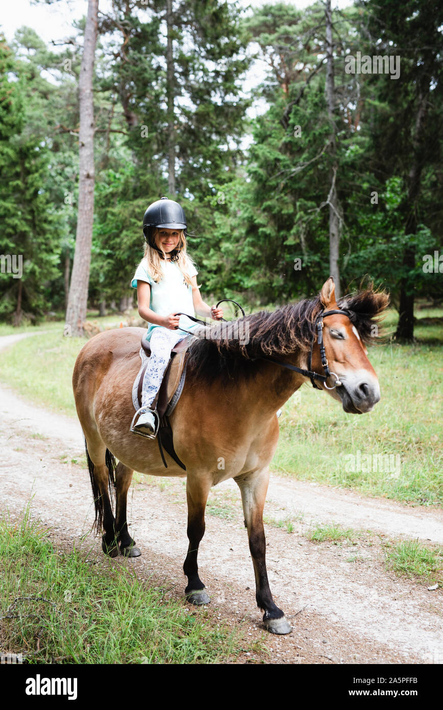 Girl riding horse Stock Photo