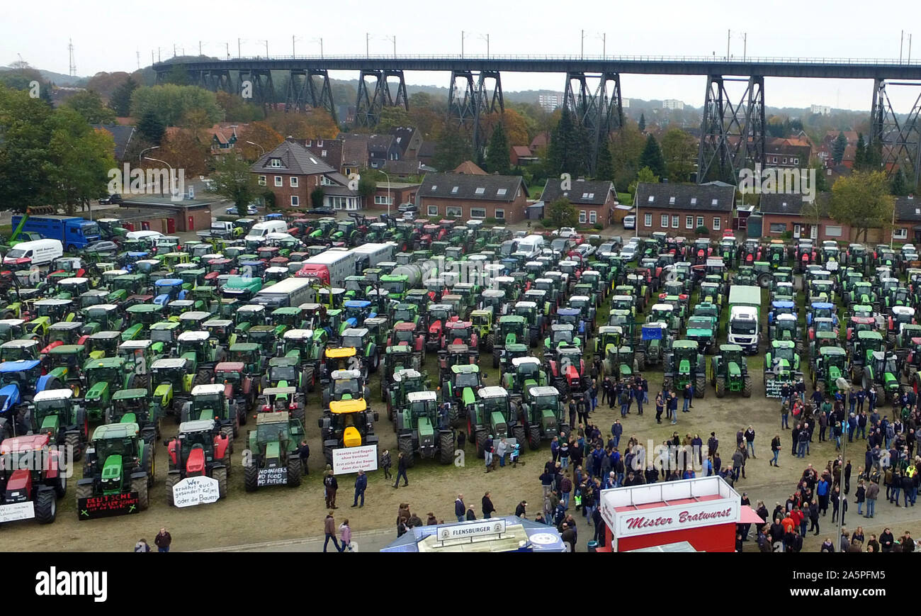 Rendsburg, Germany. 22nd Oct, 2019. Demonstrating farmers stand in front of their tractors at the demonstration. Nationwide, farmers are protesting against the federal government's agricultural policy with rallies. (recording with drone) Credit: Carsten Rehder/dpa/Alamy Live News Stock Photo
