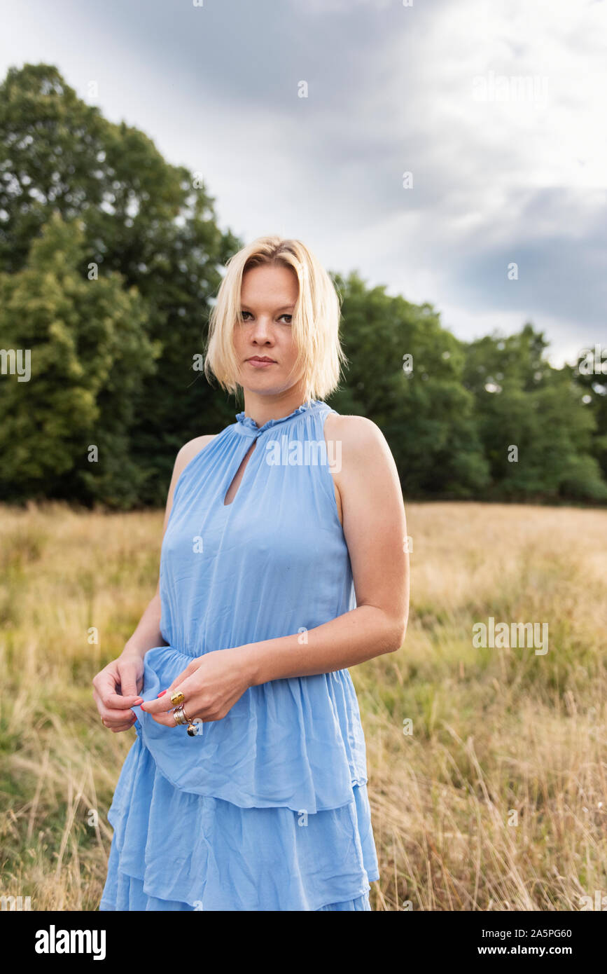 Woman blonde in blue dress hi-res stock photography and images - Alamy