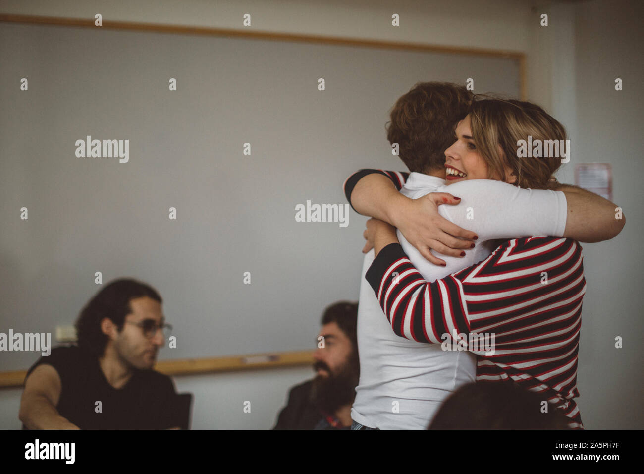 Young friends hugging smiling hi-res stock photography and images - Alamy