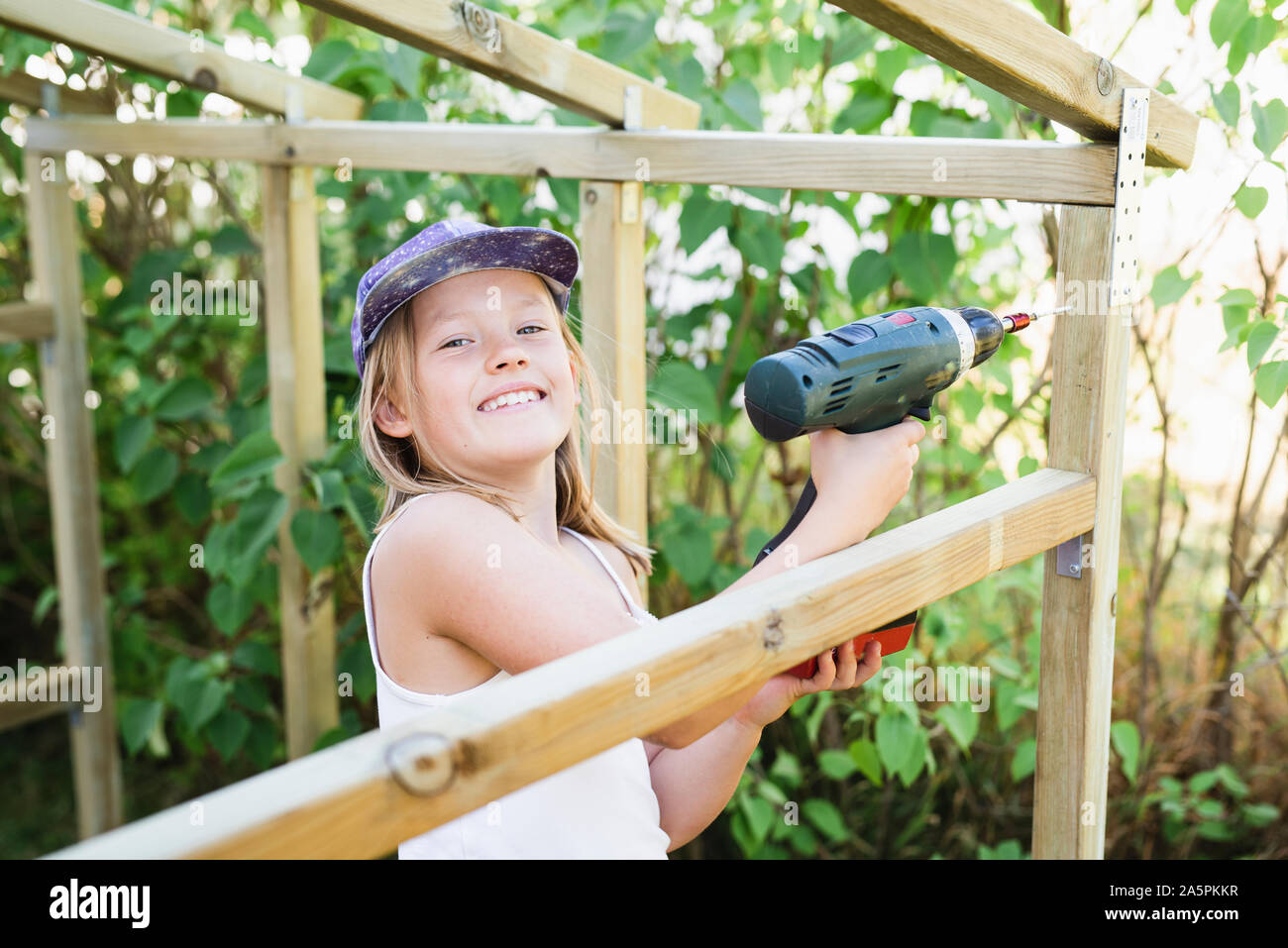 Girl with electric drill Stock Photo