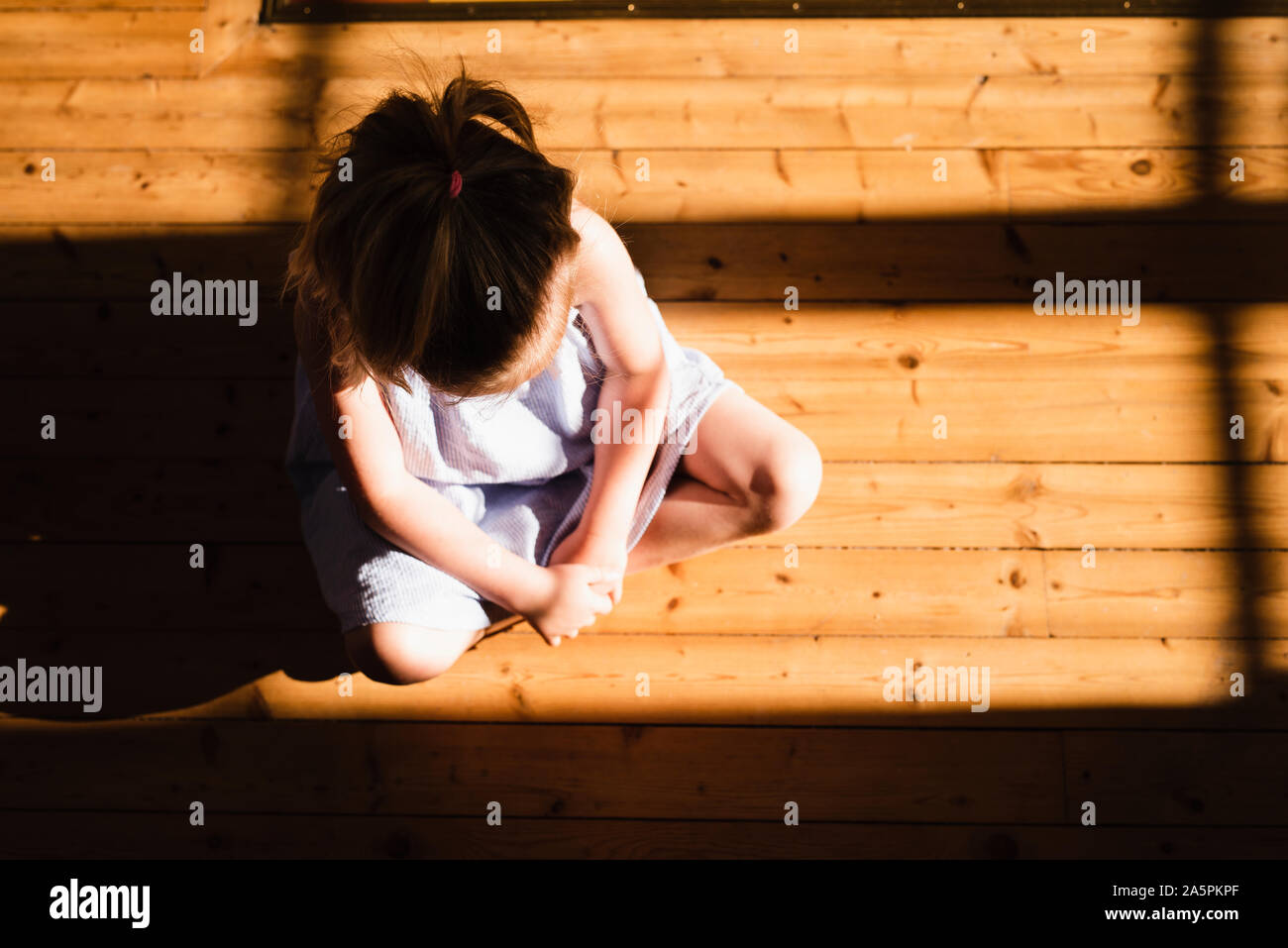 Girl sitting on floor Stock Photo