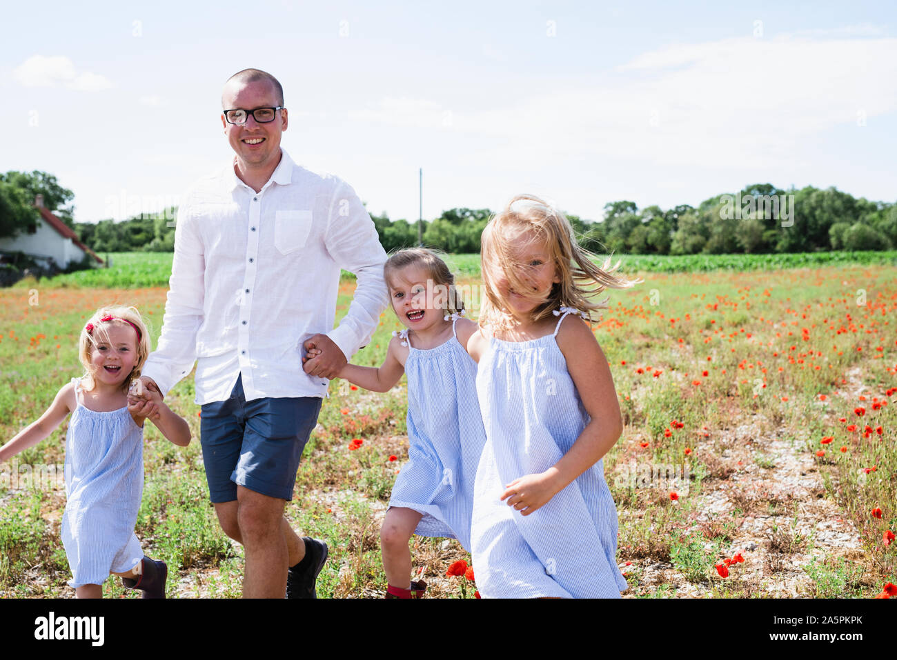 Father walking with daughters Stock Photo - Alamy