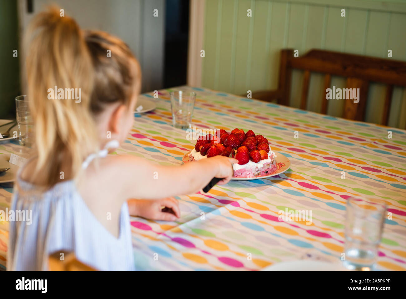 Girl cutting cake Stock Photo