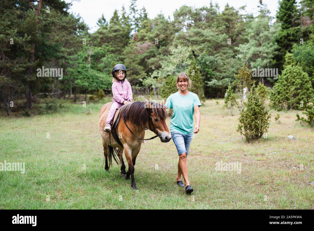 Girl horseback riding Stock Photo