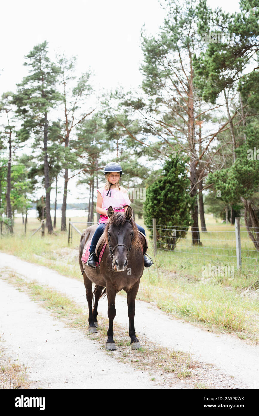 Girl horseback riding Stock Photo