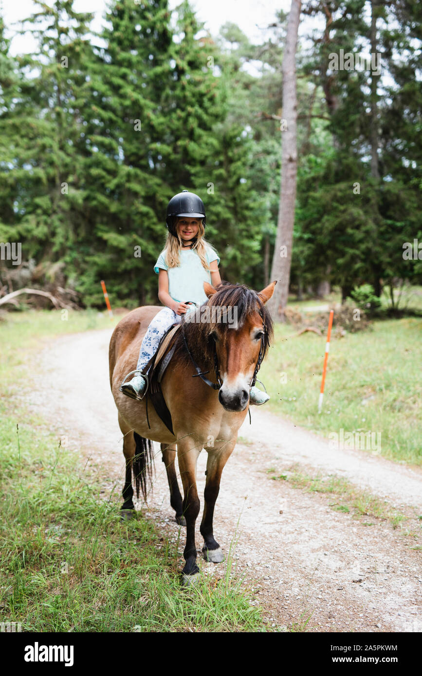 Girl horseback riding Stock Photo