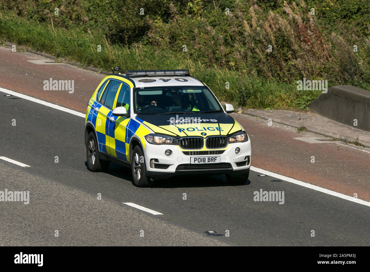 A police patrol vehicle traveling on the M6 motorway near Preston in Lancashire, UK Stock Photo