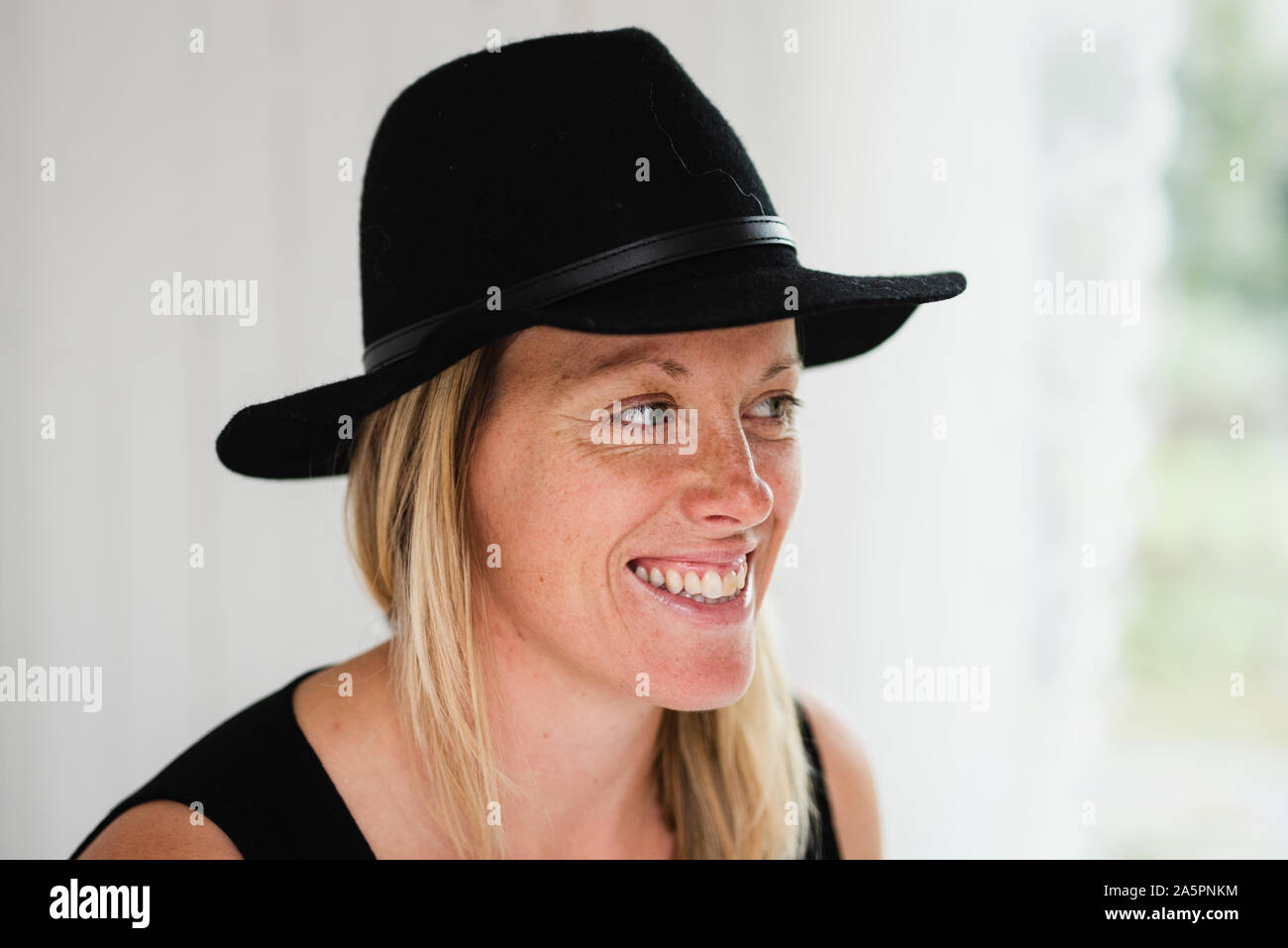 Smiling blonde woman wearing hat Stock Photo