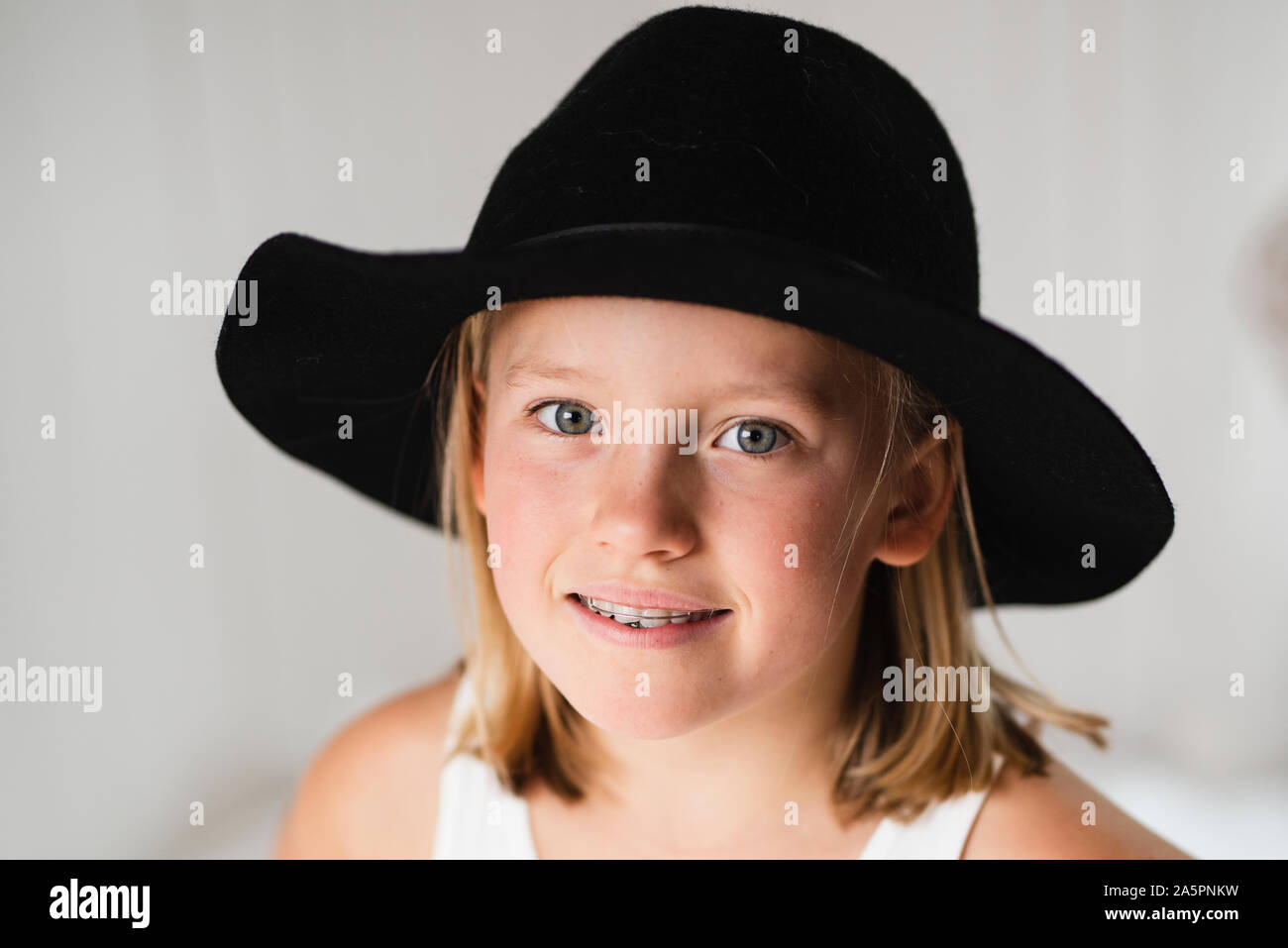 Smiling blonde girl wearing hat Stock Photo