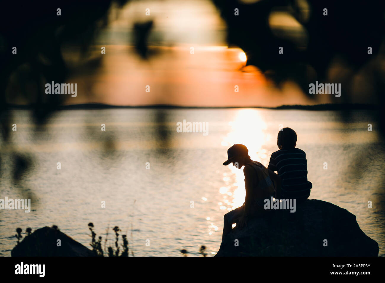Two boys sitting on rock hi-res stock photography and images - Alamy