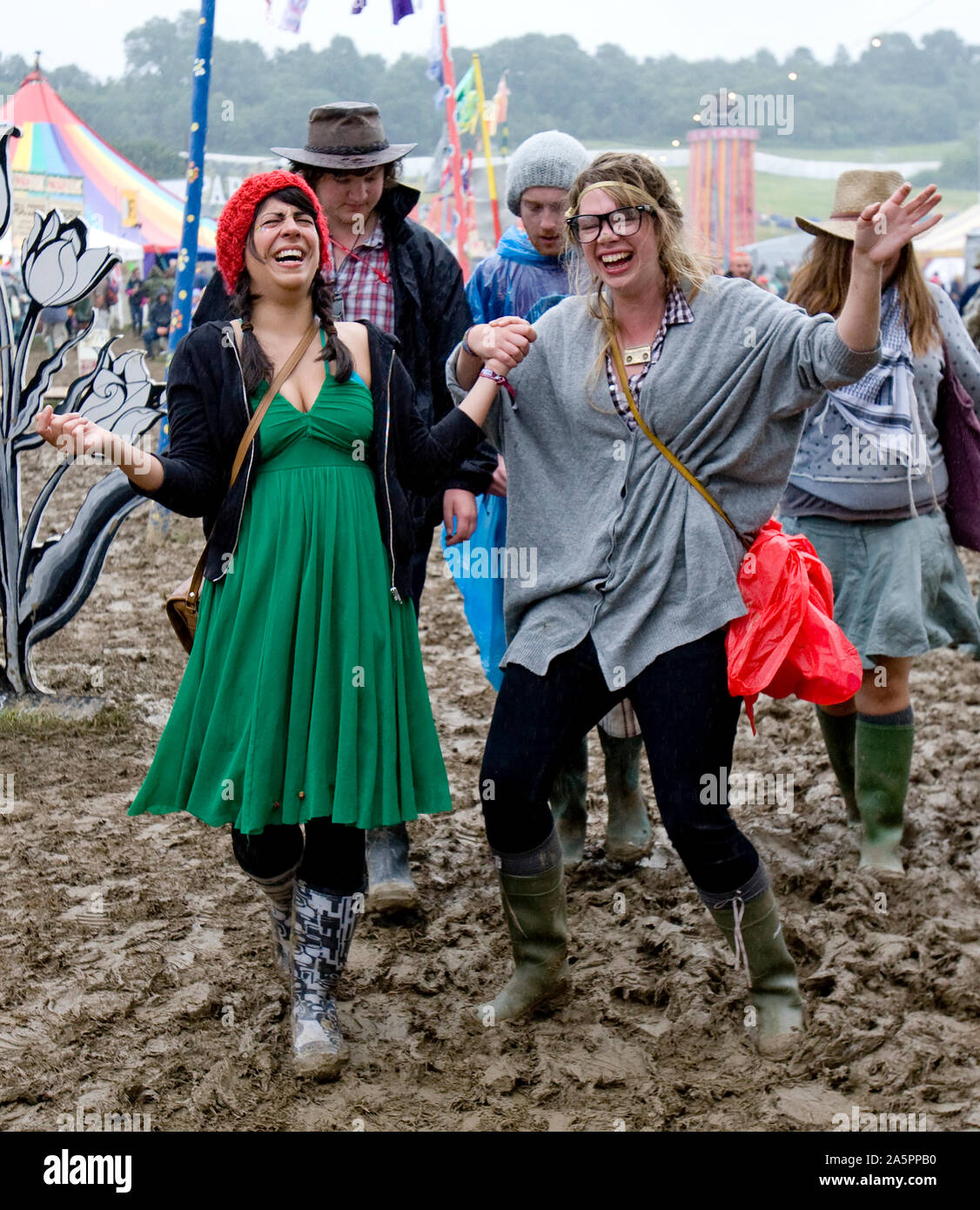 People Walking In A Field Of Mud Glastonbury Festival UK Stock Photo