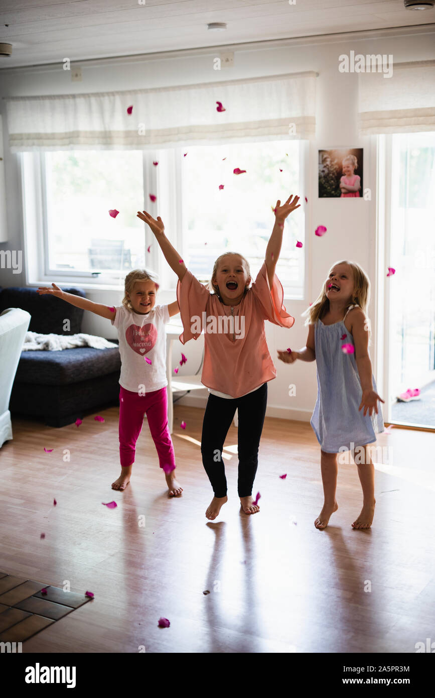 Happy girls throwing rose petals Stock Photo Alamy