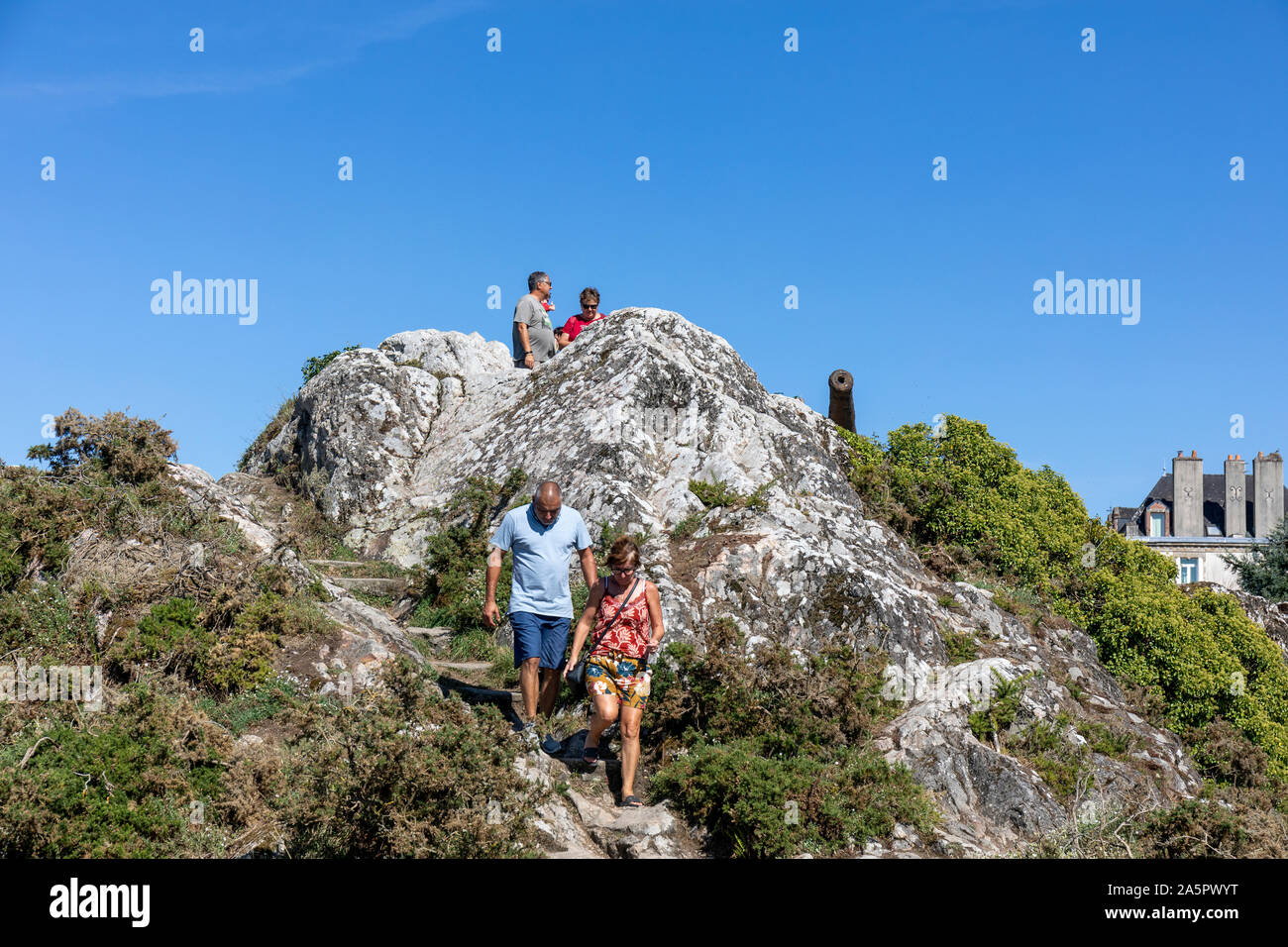 Tourists visit the famous rock and gun platform with its very rusty canon overlooking the Vilaine river Stock Photo