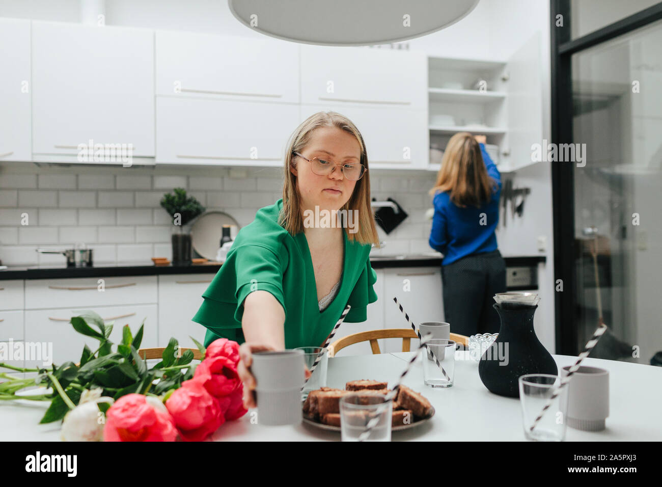 Teenage girl preparing table Stock Photo - Alamy