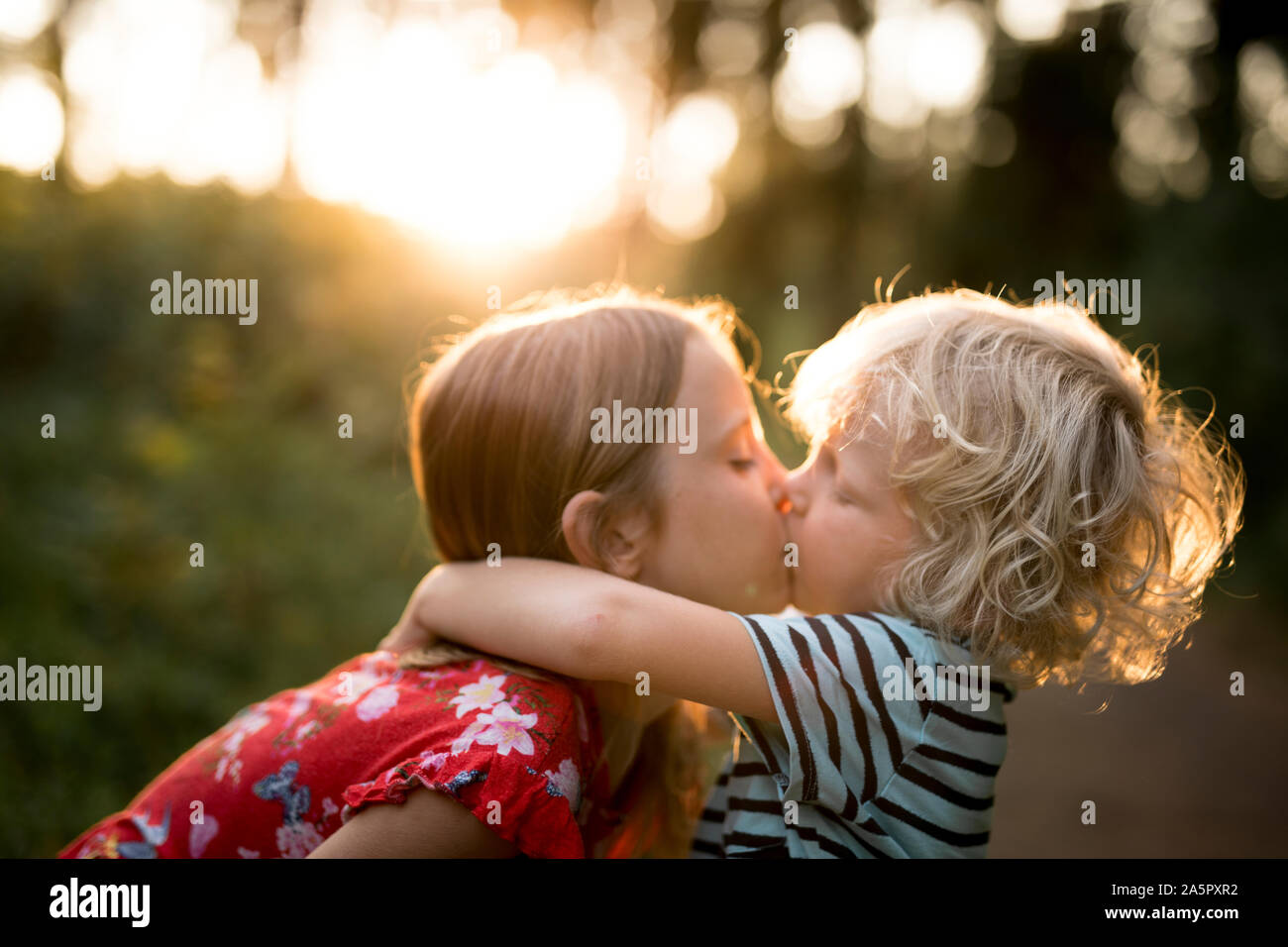 Brother and sister kissing Stock Photo - Alamy