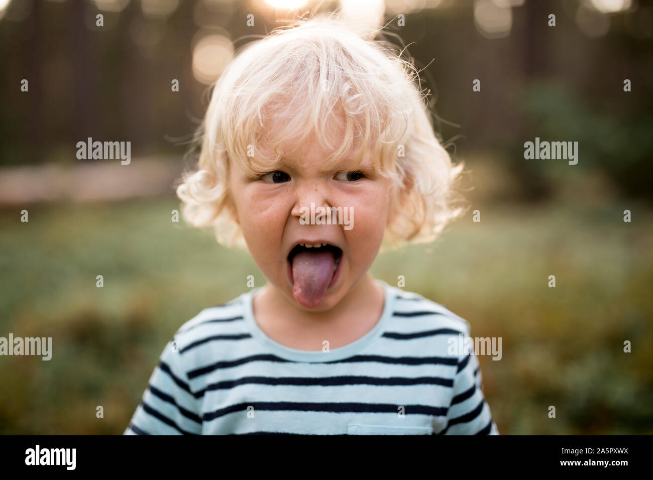 Boy sticking his tongue out Stock Photo Alamy