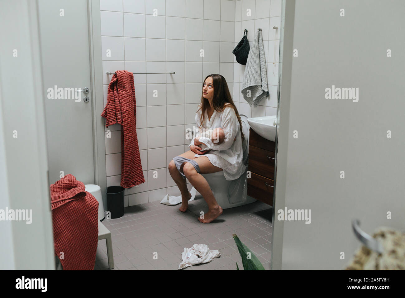 Mother with baby on toilet Stock Photo