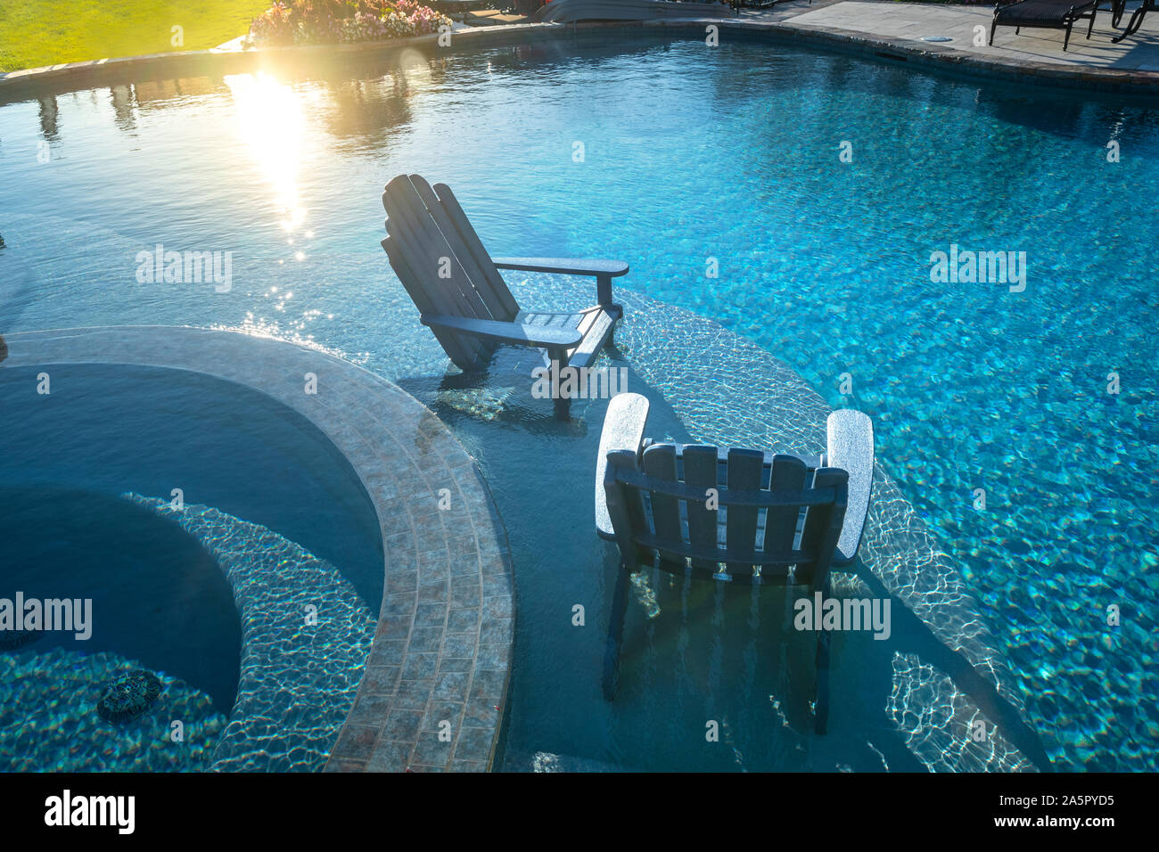 Two Adirondack Chairs in the swimming pool Stock Photo