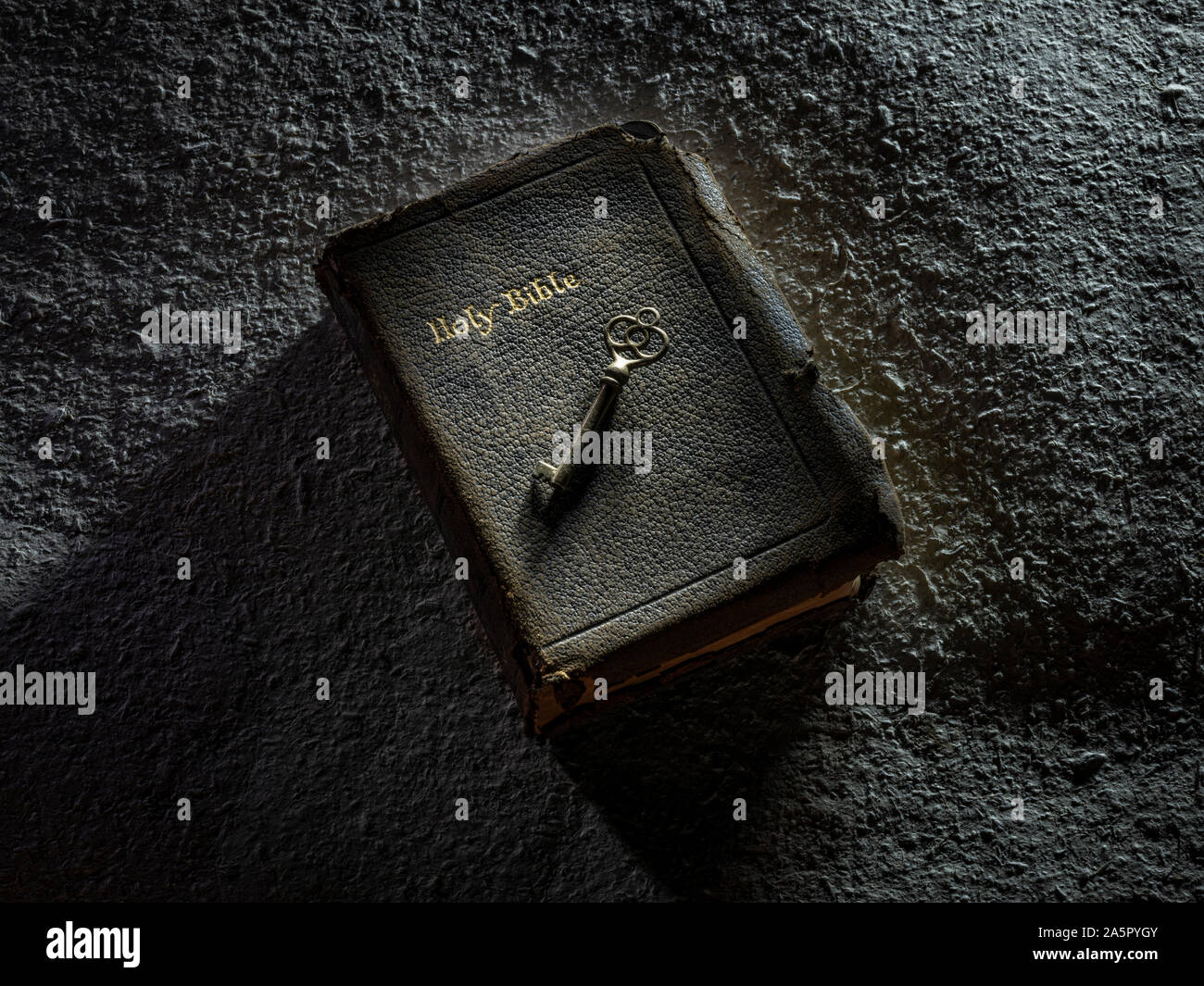 Key On Top Of Open Holy Bible Stock Photo