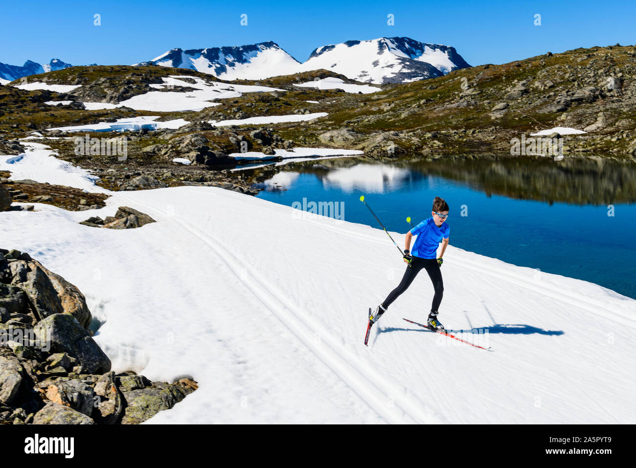 Boy cross-country skiing in mountains Stock Photo